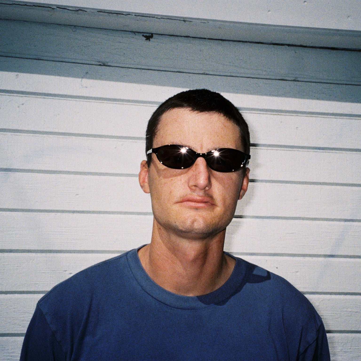 Zachary Kovacs wearing SAD Eyewear Celeste oval sunglasses in black with polarized grey UV protection lenses