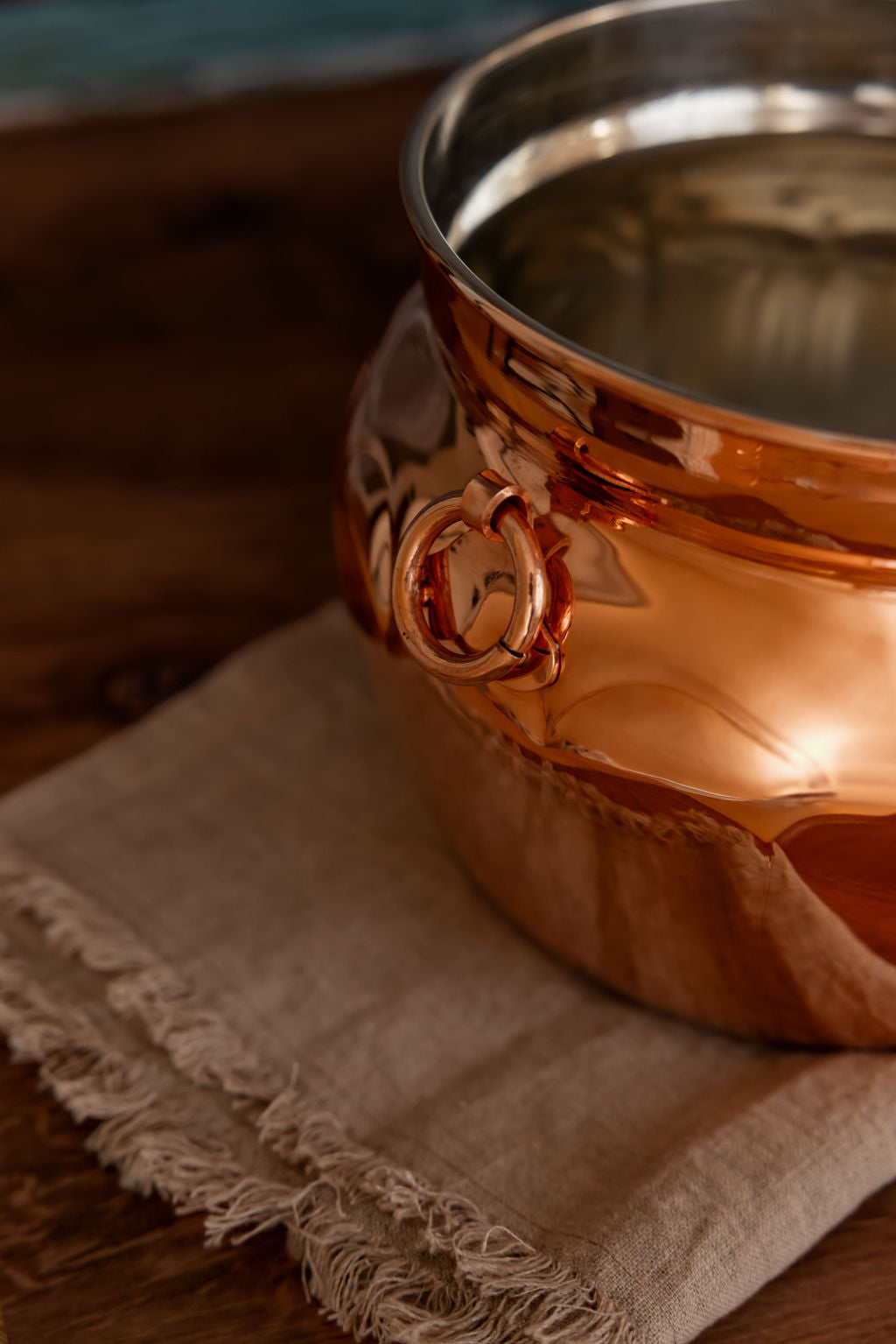Copper mule mug on a textured cloth with a blurred background.