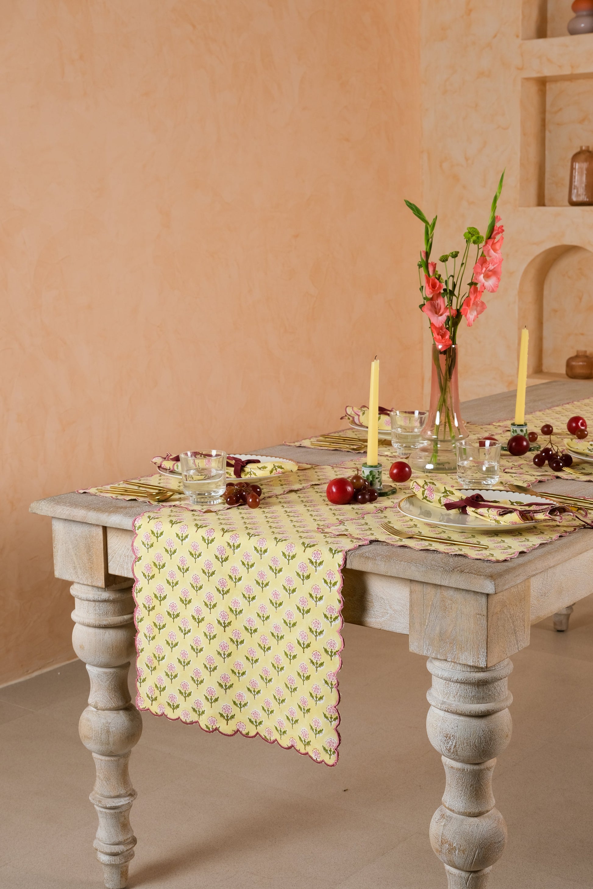 Long wooden table with Mona Scallop tablerunner and place settings