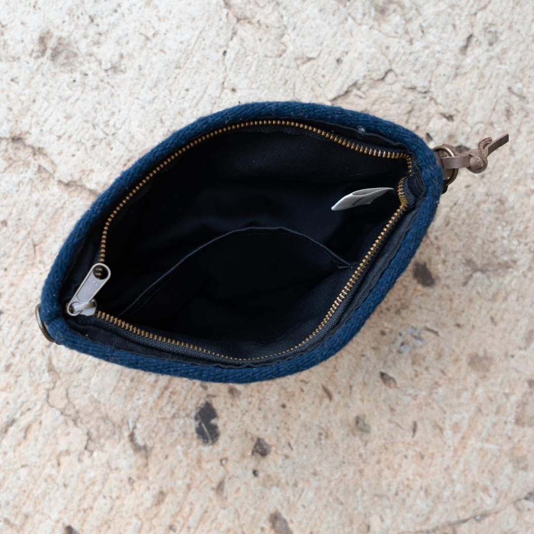 Interior view of handwoven convertible clutch with Zapotec pattern in bold colors; can be used as a pouch, wristlet, or crossbody with included leather straps and internal pocket.