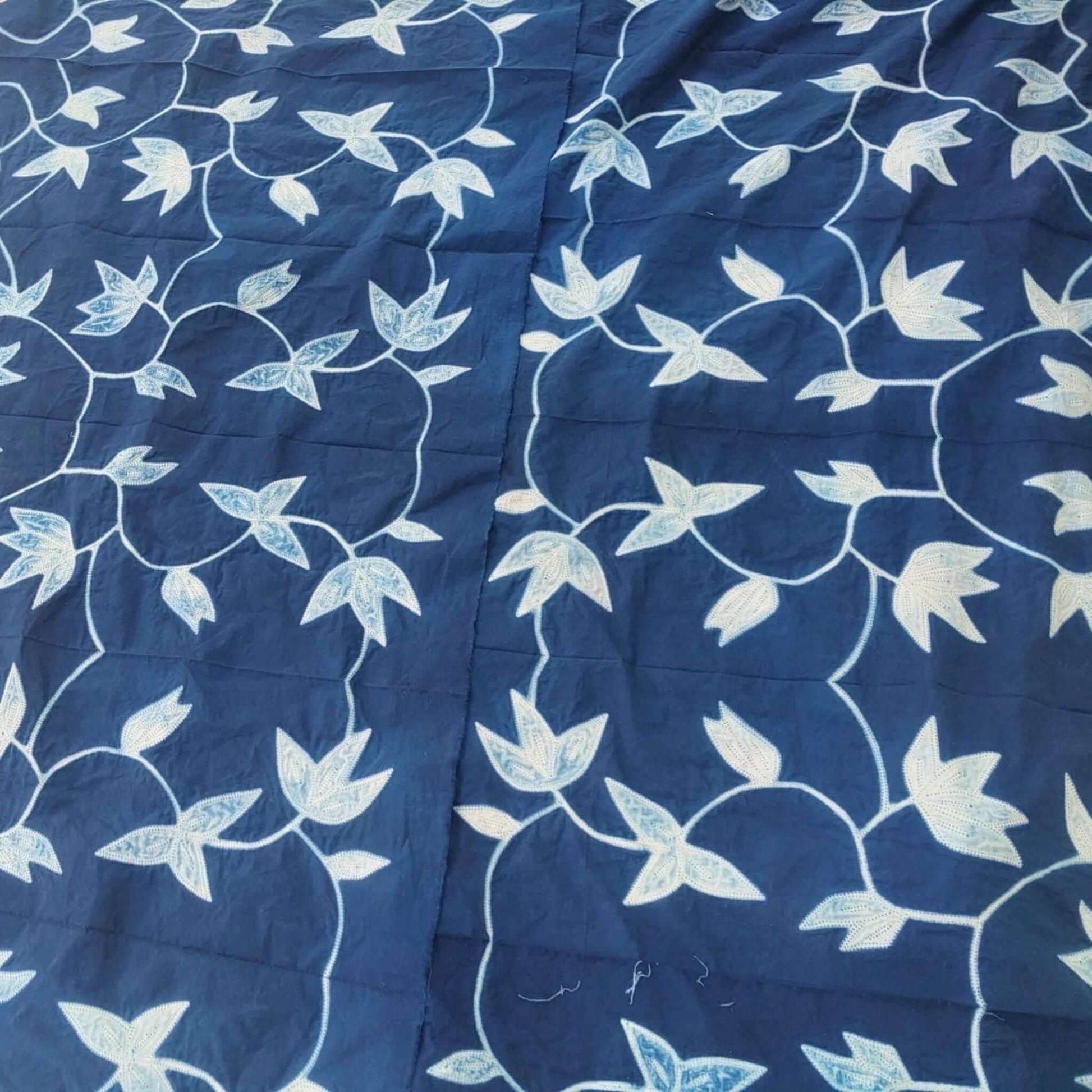Folio Indigo Handcrafted Shibori Cotton Table Napkins ( set of 4 ) with intricate floral pattern in indigo and white.