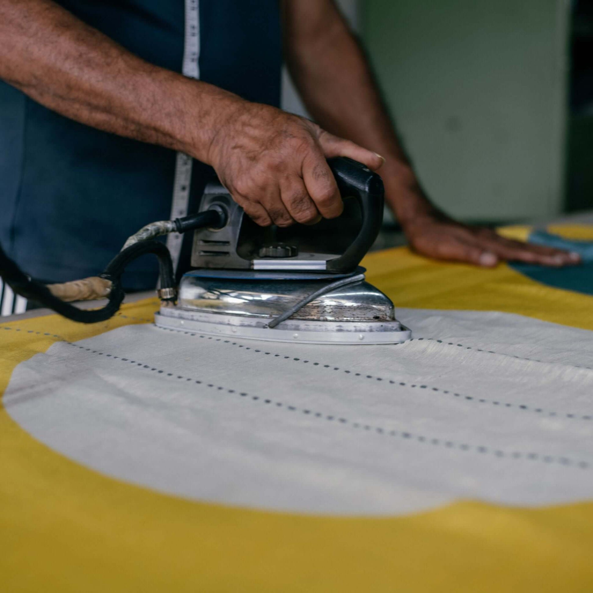 Cirq Sun Yellow Green Circle Pattern Hand Embroidered  Linen Silk Handloom Scarf being ironed with a vintage iron.