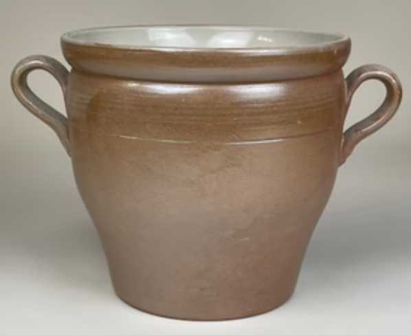 Brown ceramic vase with handles on a white background