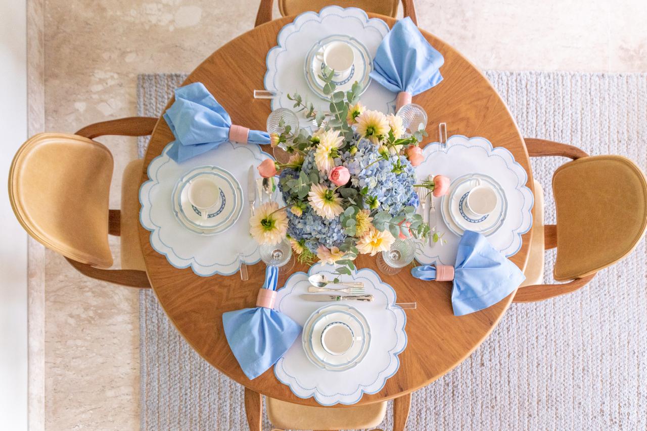 The blue Victoria impermeable placemat with Victorian-style border detail by Talah Home