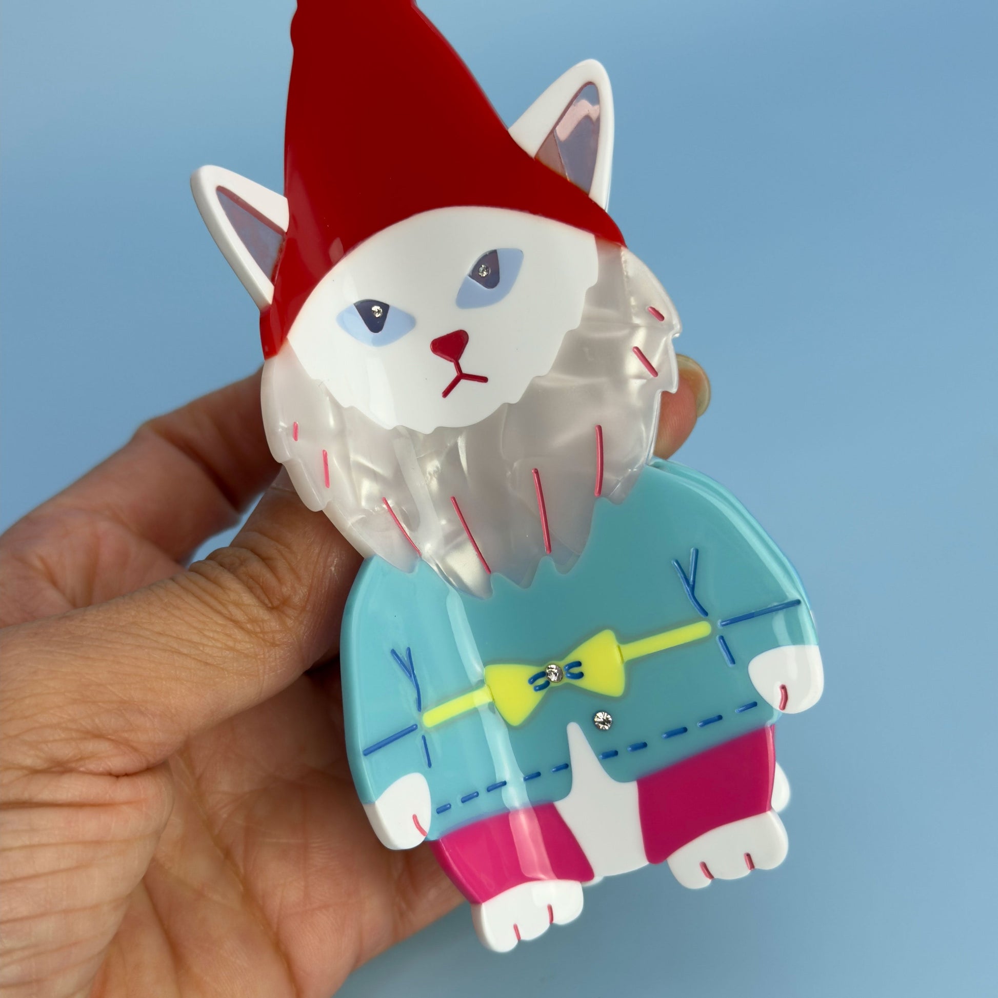 Cat garden gnome From Lawn Ornament to Hair claw Accessory World Traveler in red, blue and pink. Handmade on cellulose acetate, with splice technique, exquisite miniature details and crystals, that are tied directly to its value and make them unique and special. 