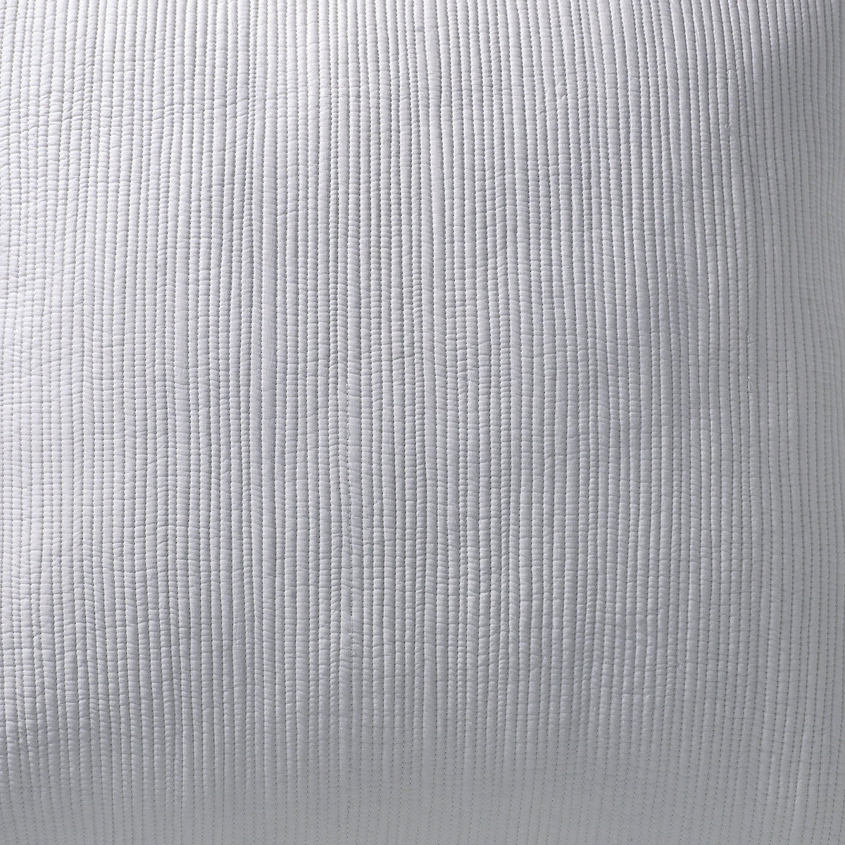 KS-168-2036_4|Close-up of a crisp white textured coverlet with subtle vertical stitching, showcasing its clean, inviting fabric.
