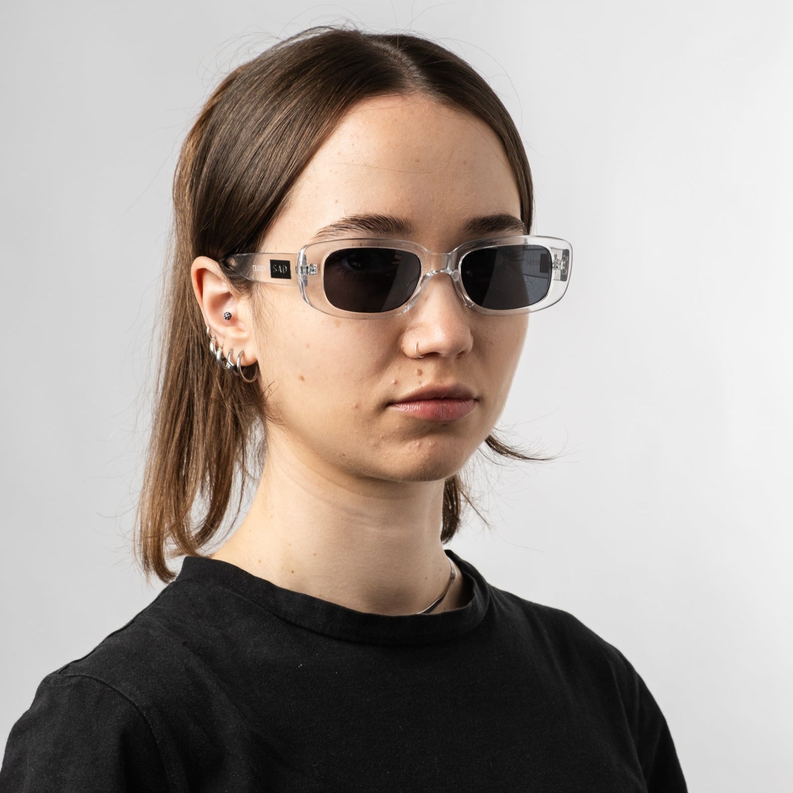 Female wearing Sad Eyewear Bouquet rectangle sunglasses clear frames with uv protection lenses