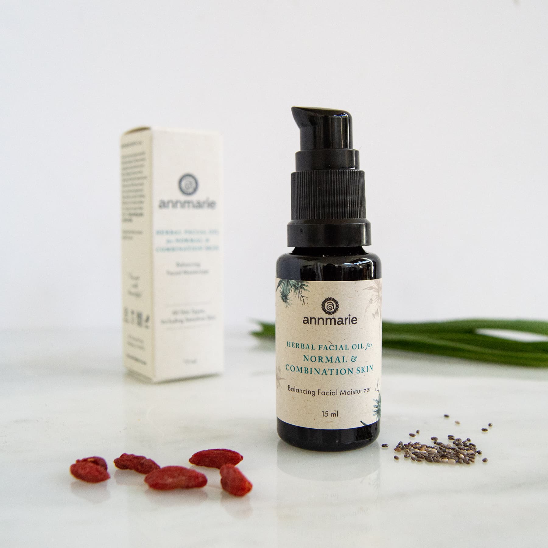 Herbal Facial Oil for normal and combination skin with product box and botanical ingredients on white background.