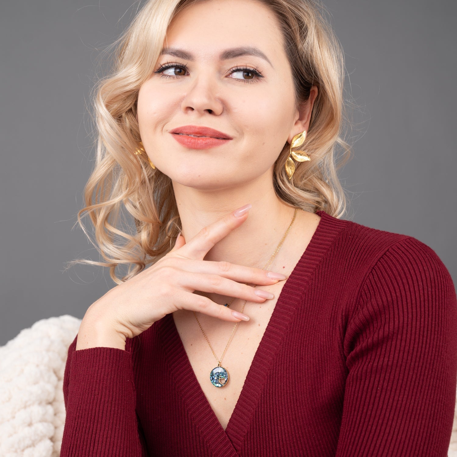 Photo of a woman wearing beautiful canopy earrings, gold jewelry, jewelry website, fashion jewelry like pandora