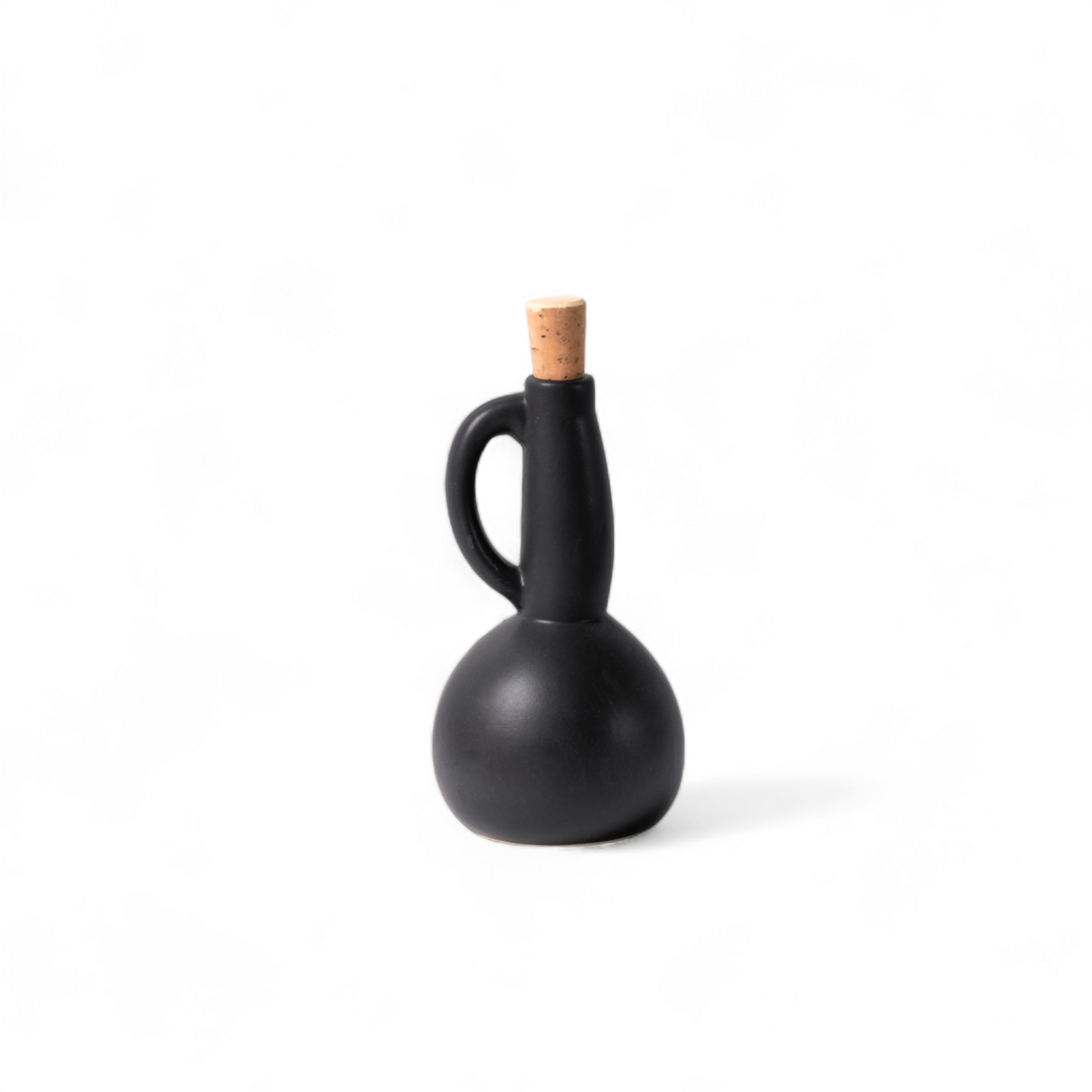 White ceramic olive oil dispenser with matte finish and cork stopper, displayed against a white background.