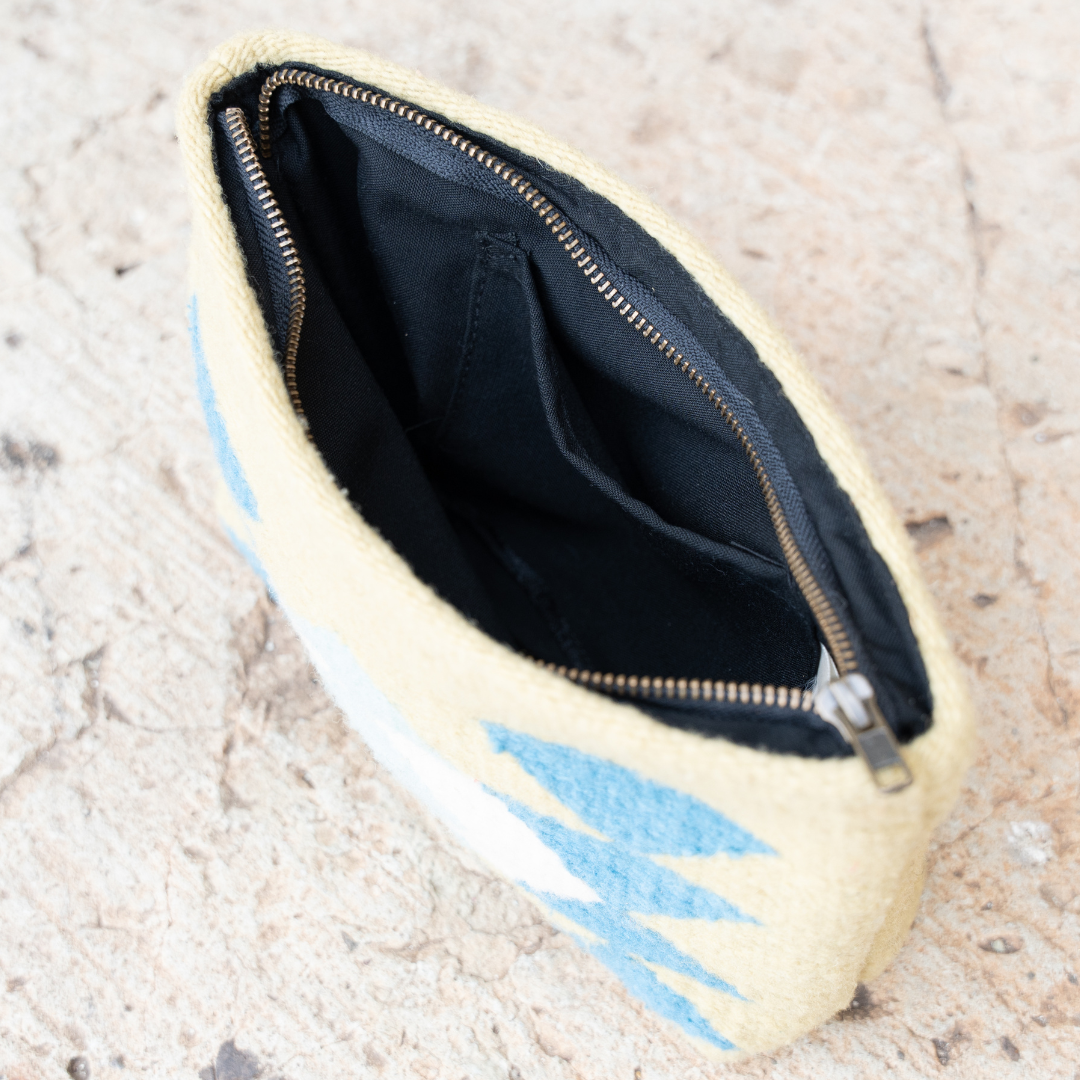 Interior view of handwoven pouch with abstract Zapotec butterfly design in bright spring colors, featuring internal pocket; perfect for makeup, wallet, or daily essentials.