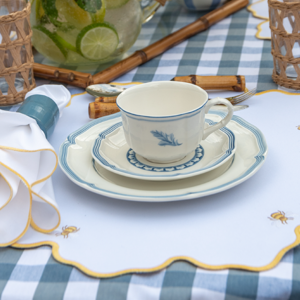Bumble bee impermeable placemat with hand-stitched bee embroidery and yellow wavy border by Talah Home