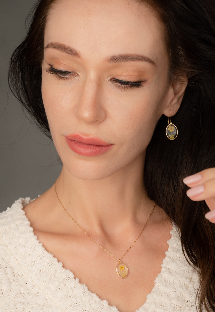 A woman wearing set of matching earrings and necklace, floral jewelry set, quality jewelry for women, cute earrings, freedom business, gold earrings and necklaces