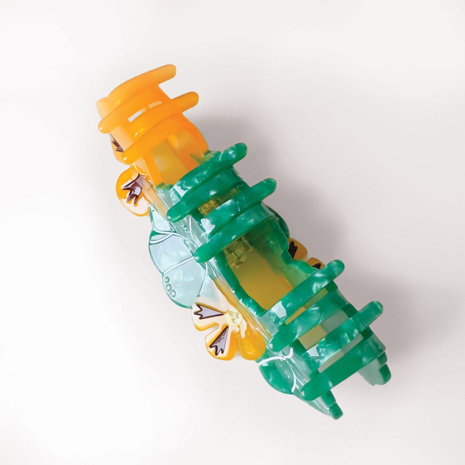 Nasturtium garden green and orange hair claw for a sustainable gardening. Handmade on cellulose acetate, with splice technique, exquisite miniature details and crystals, that are tied directly to its value and make them unique and special. 