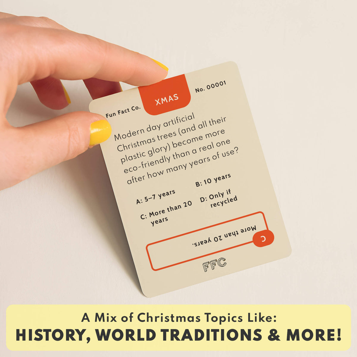 Card with Christmas-themed trivia question and answer, held by a hand.