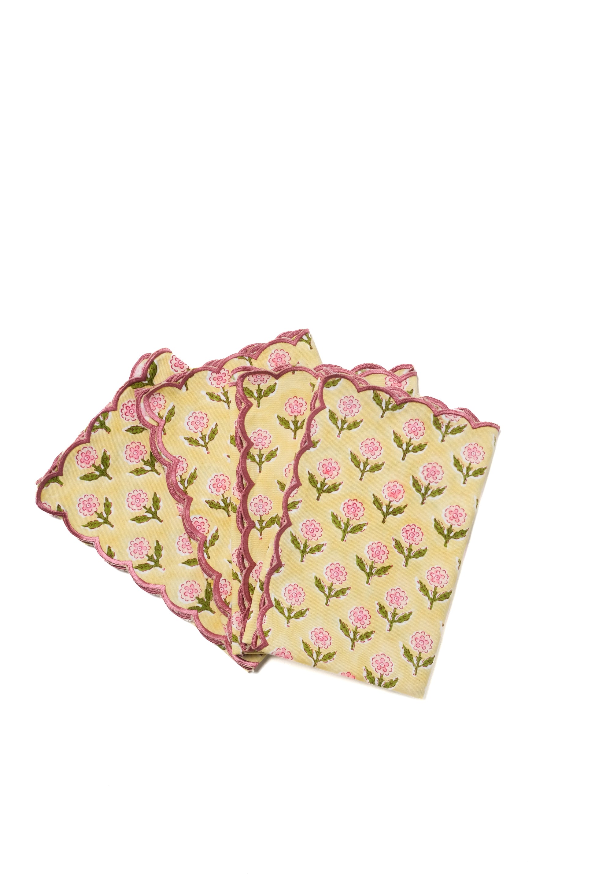 Inner Child stacked yellow scallop napkins with pink flowers