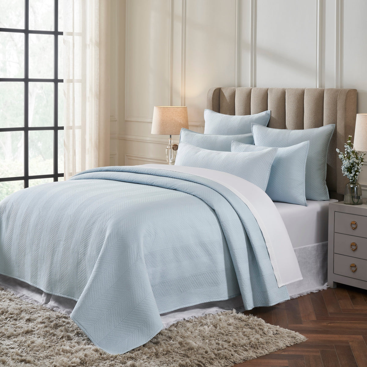 CL-262-9496_2|Cozy light blue quilted coverlet featuring a chic herringbone pattern, adorning a bed in a bright, modern bedroom.