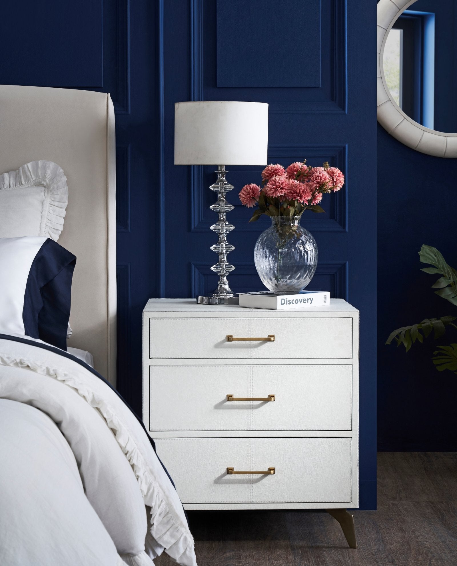 FN-5200-X-1_1|Elegant white three-drawer nightstand with gold handles, paired with a crystal lamp and floral vase. Bedroom furniture.
