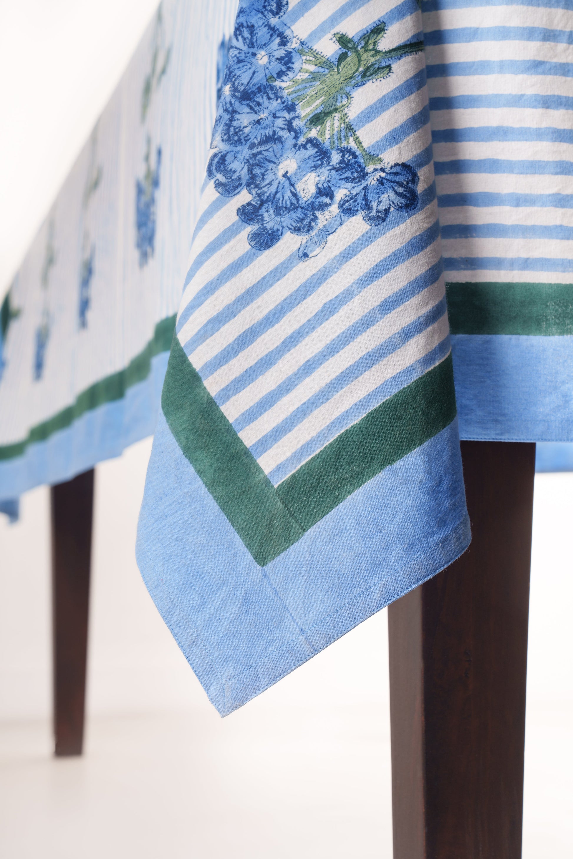 Blue hydrangea blockprint tablecloth with striped pattern and green borders