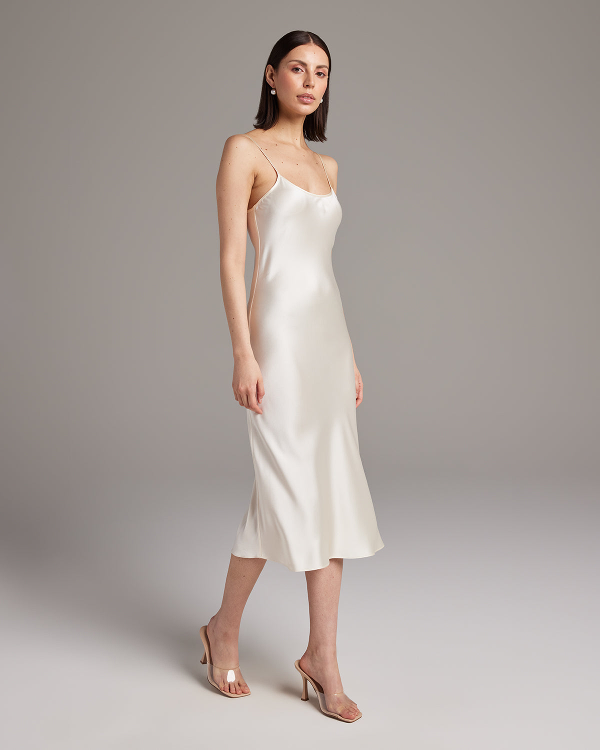 Model wearing a white Midi Slip Dress with spaghetti straps