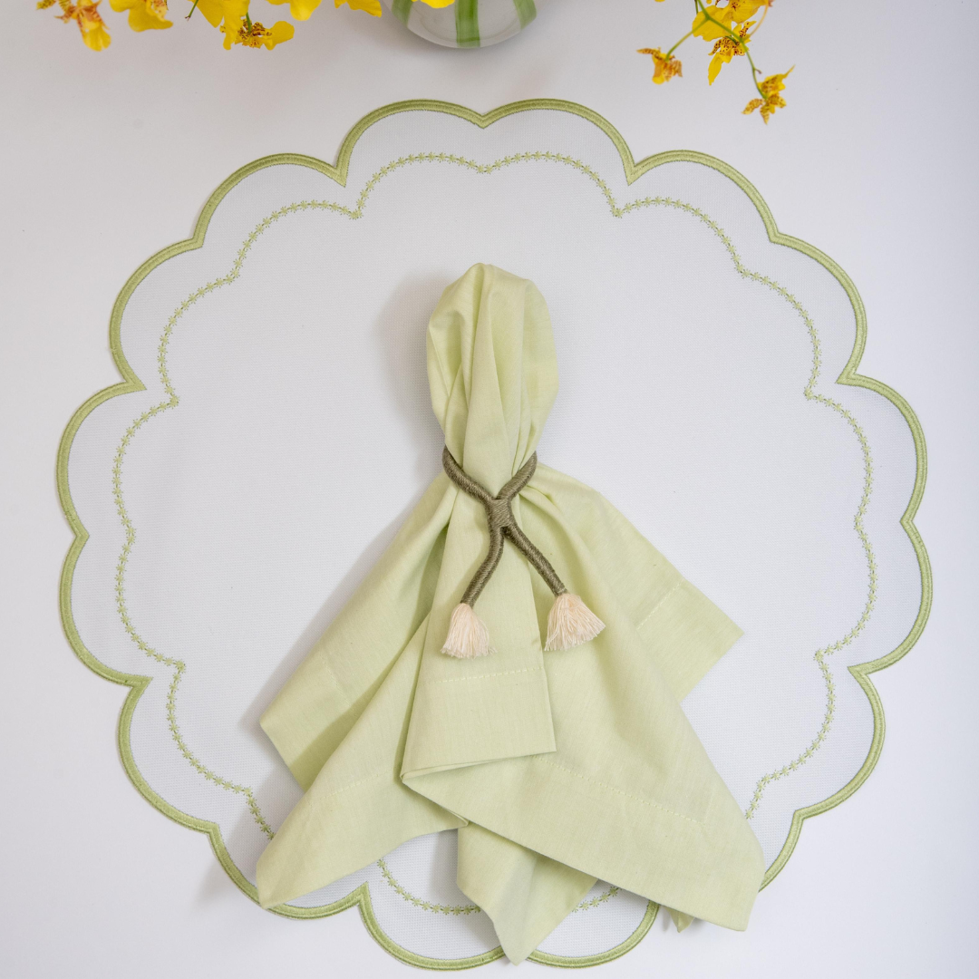 The green Victoria impermeable placemat with Victorian-style border detail by Talah Home