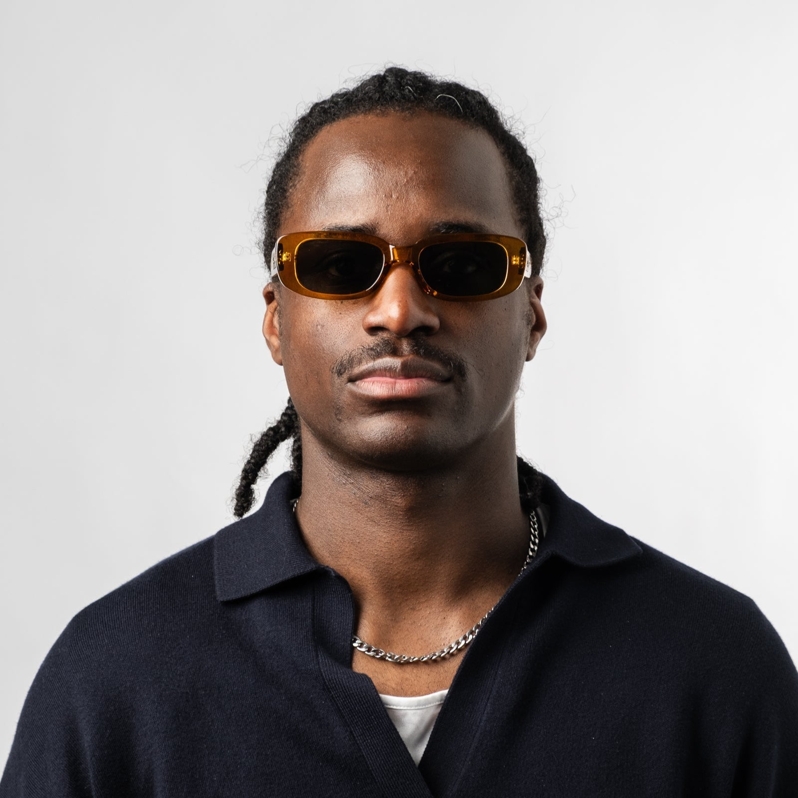 Male wearing Sad Eyewear Bouquet rectangle sunglasses in amber with UV protection lenses