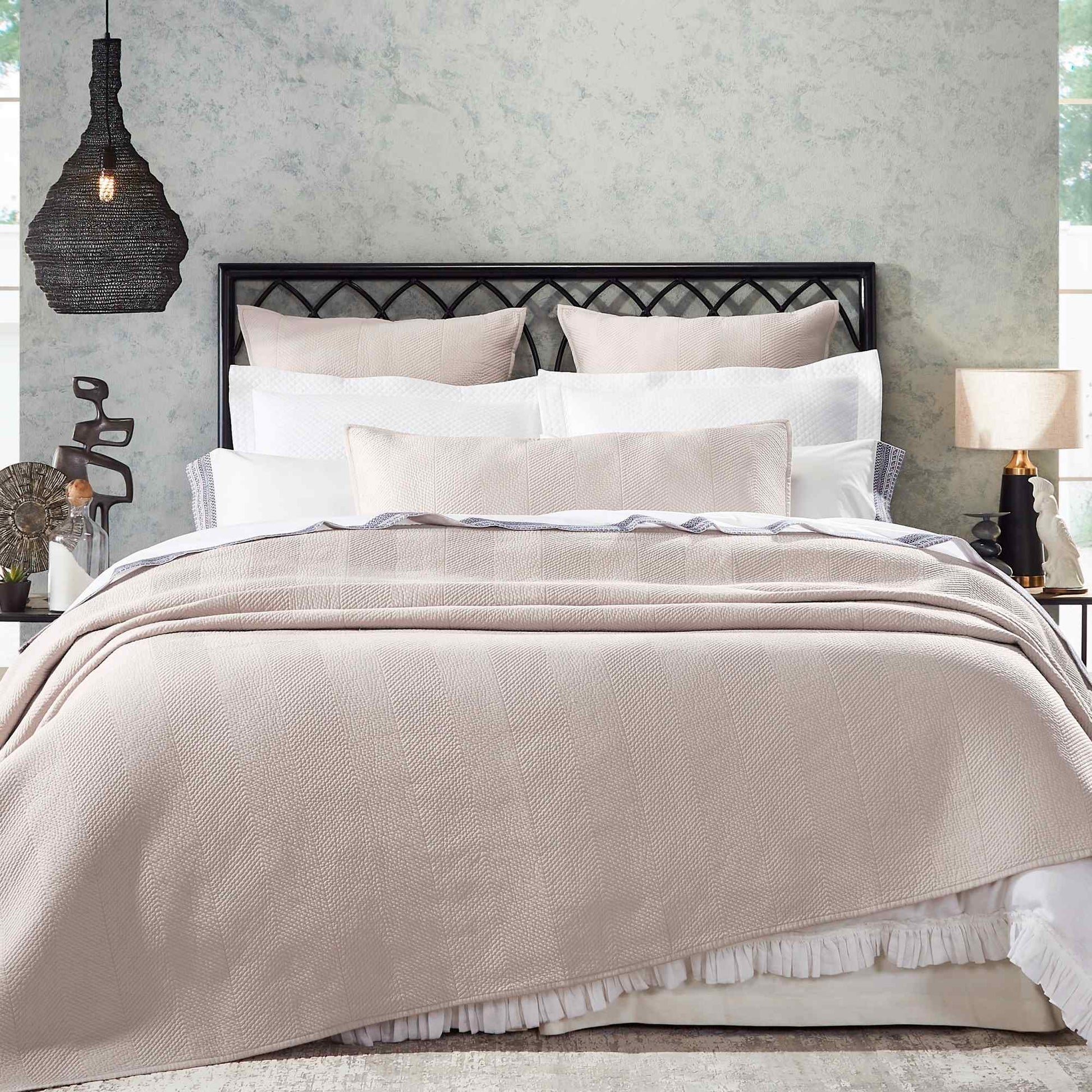 CL-171-11096-LOT1A_1|Elegant beige herringbone quilted coverlet draped over a bed, adding luxurious texture to modern bedroom decor.