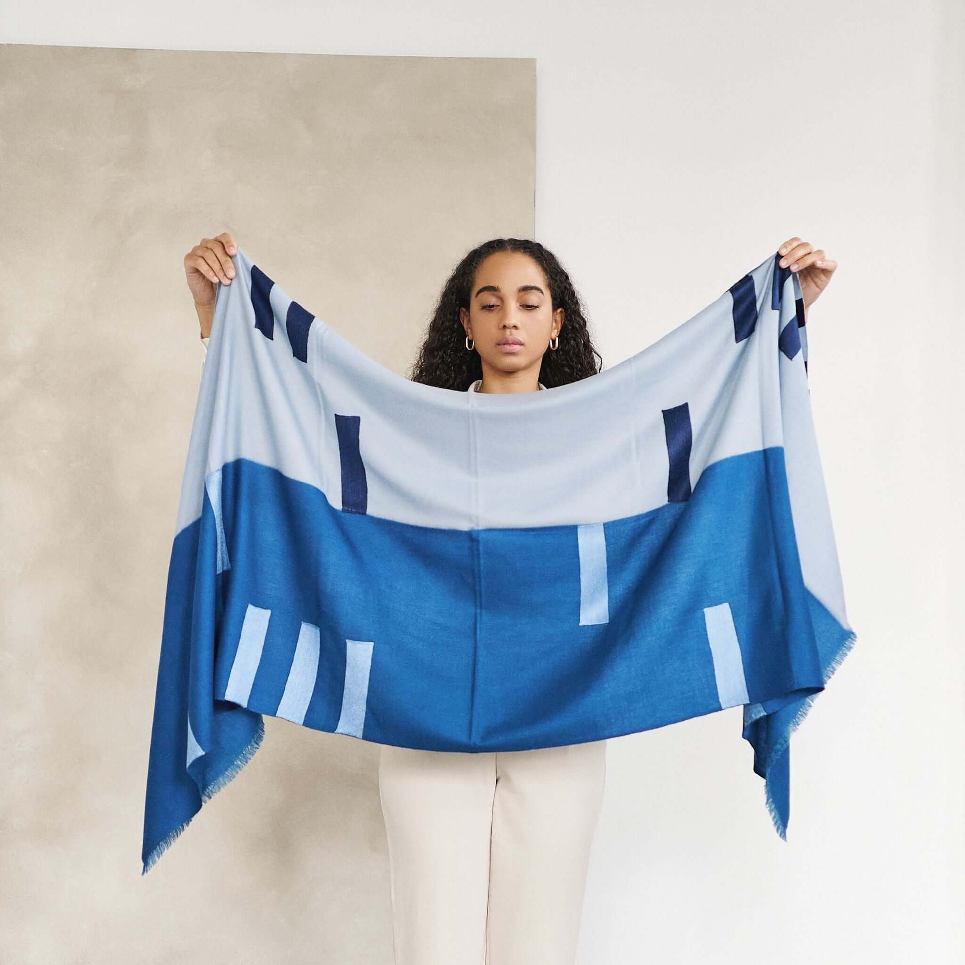 Harbor Blue Silk Merino Hand Woven Hand Embroidered Modern Artisanal Scarf held by a model showcasing its design.