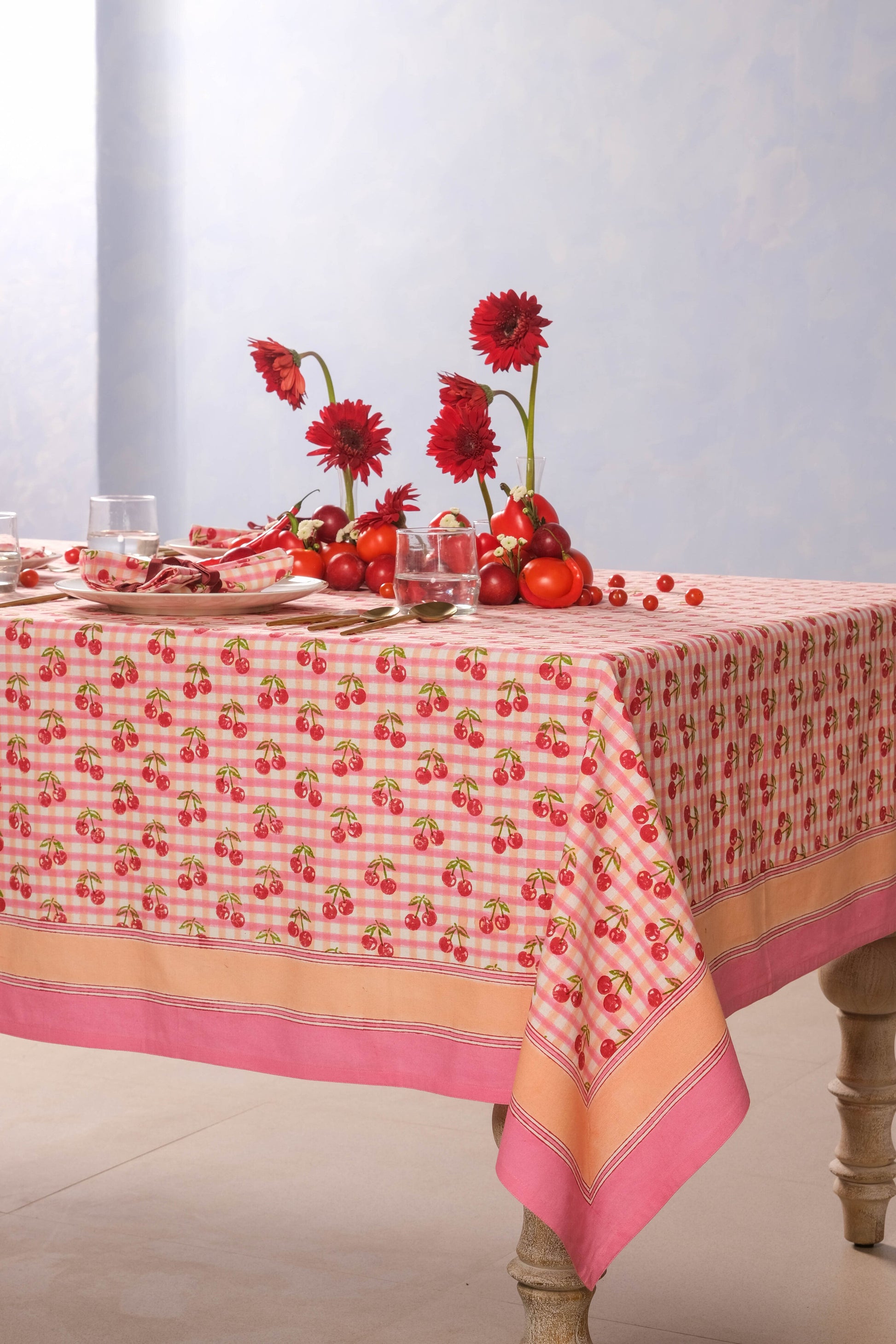 Inner Child cherry blockprint red gingham tablecloth draped over table