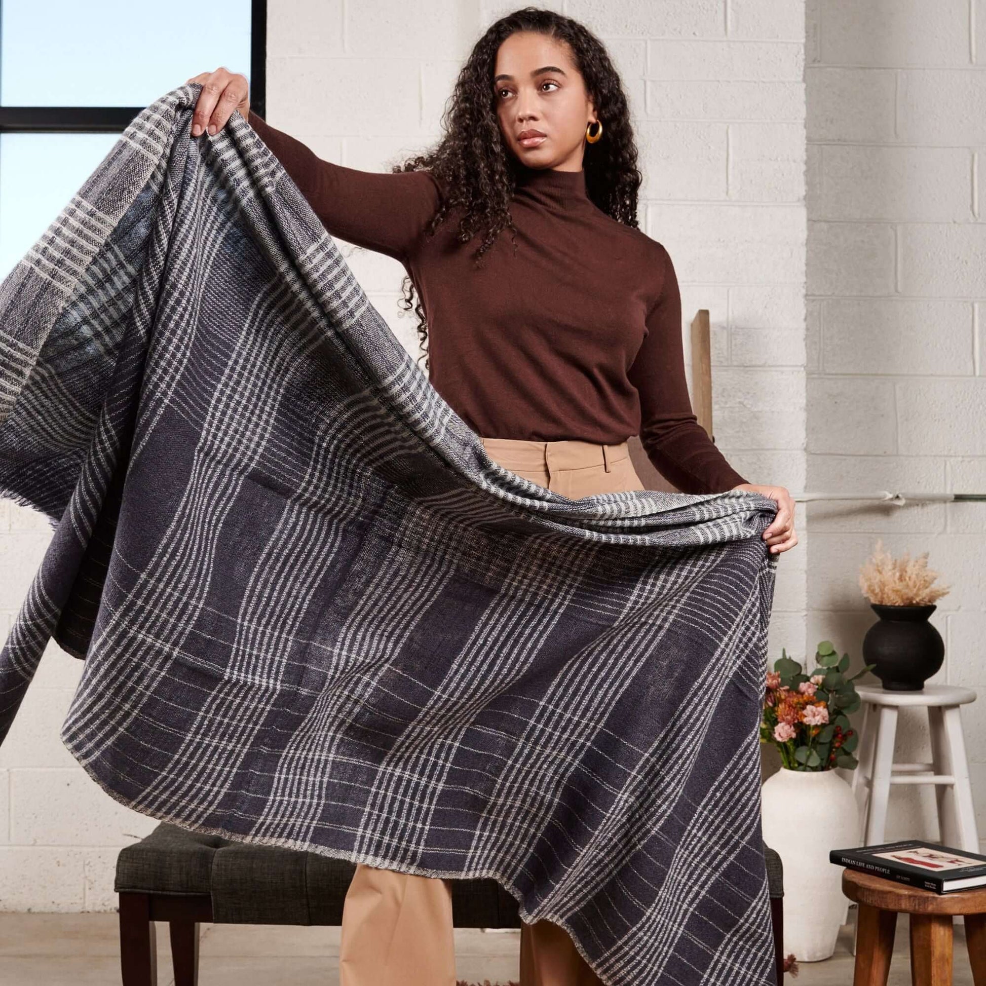 Model displaying the Alloy Dark Blue Stripes Pattern Soft Merino Linen Handloom Throw in a stylish indoor setting.