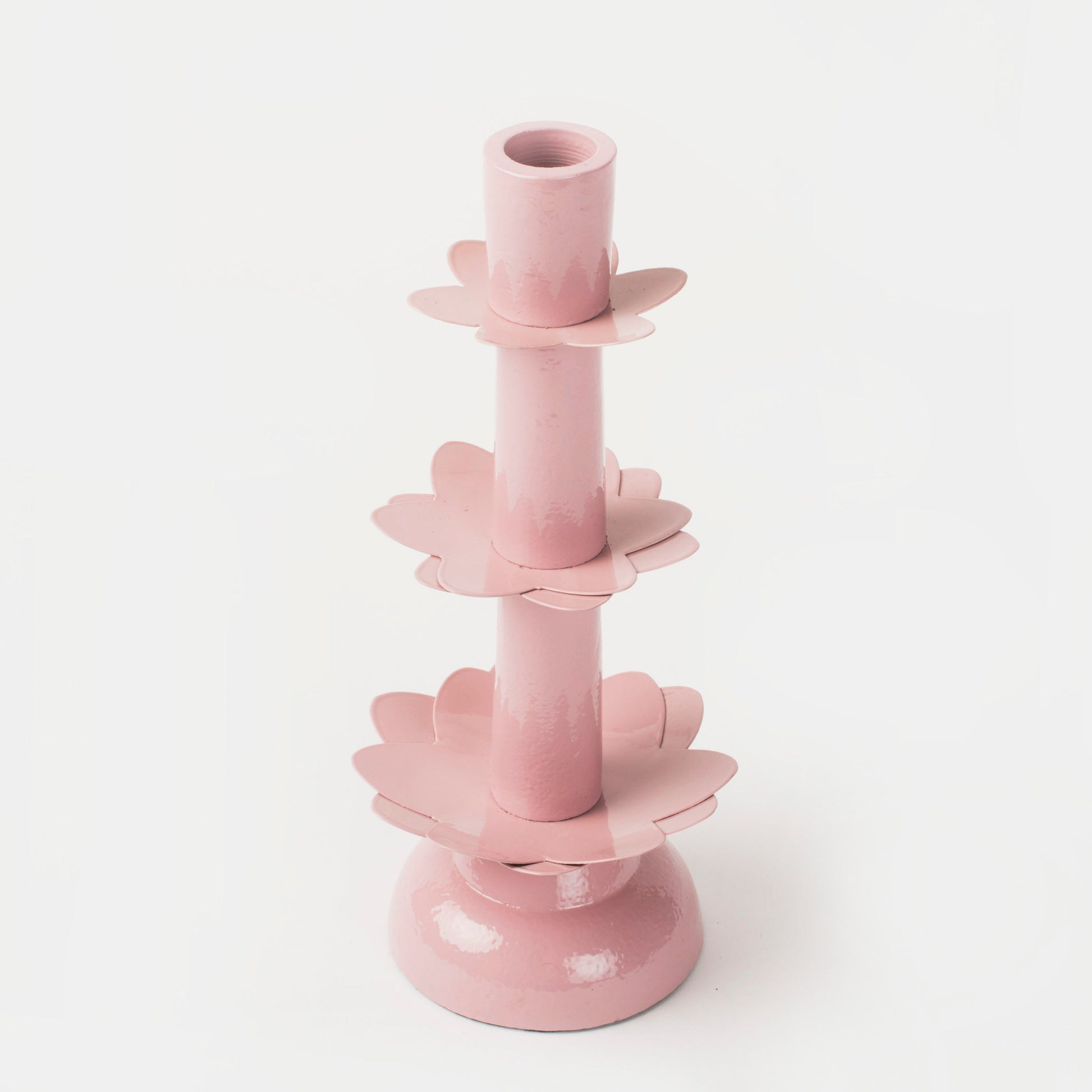 Lifestyle shot of the Lotus Bloom candlestick in a warm, sunlit room, highlighting its unique tiered petal design.