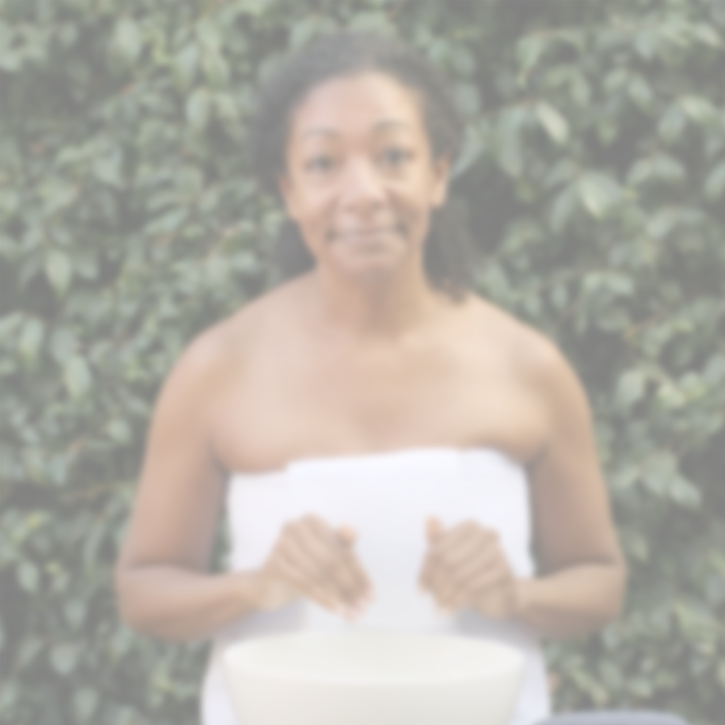 Video of woman outdoors demonstrating how to apply Annmarie skincare product during facial routine.