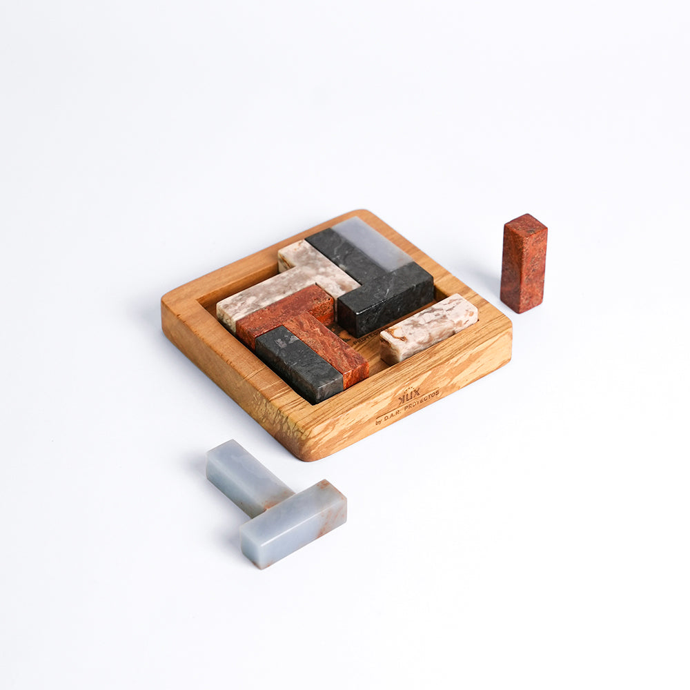 Multi-stone 3D Tetris gemstone puzzle showcasing a vibrant array of natural Andean colors on a white background.
