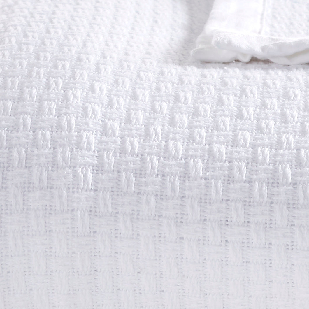 BL-855-11096_4|Close-up view of a soft, textured white basket weave blanket, highlighting its unique pattern and comfortable feel.