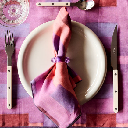 Lavender napkin rings styled on folded linen napkins on elegant table setting - Goldie Home