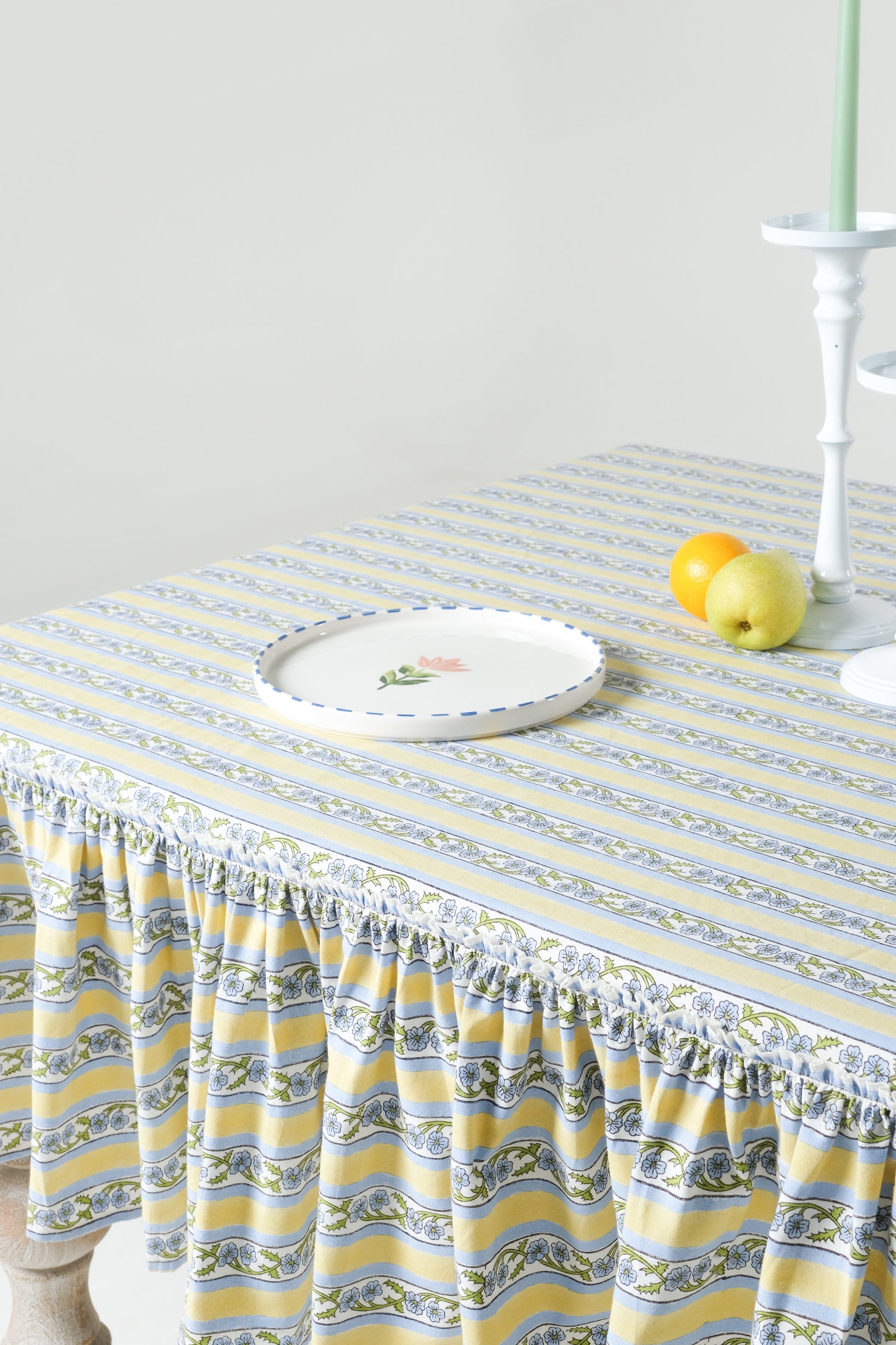 Inner Child Provence ruffled butter yellow blockprint tablecloth close-up with white plate