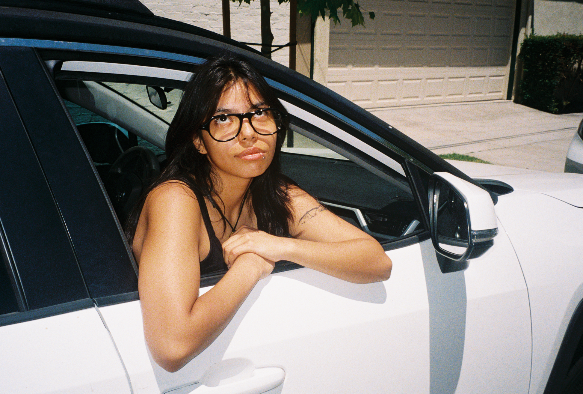 Woman wearing SAD Eyewear Ash aviator rectangle glasses in black with clear blue light blocking protection lenses