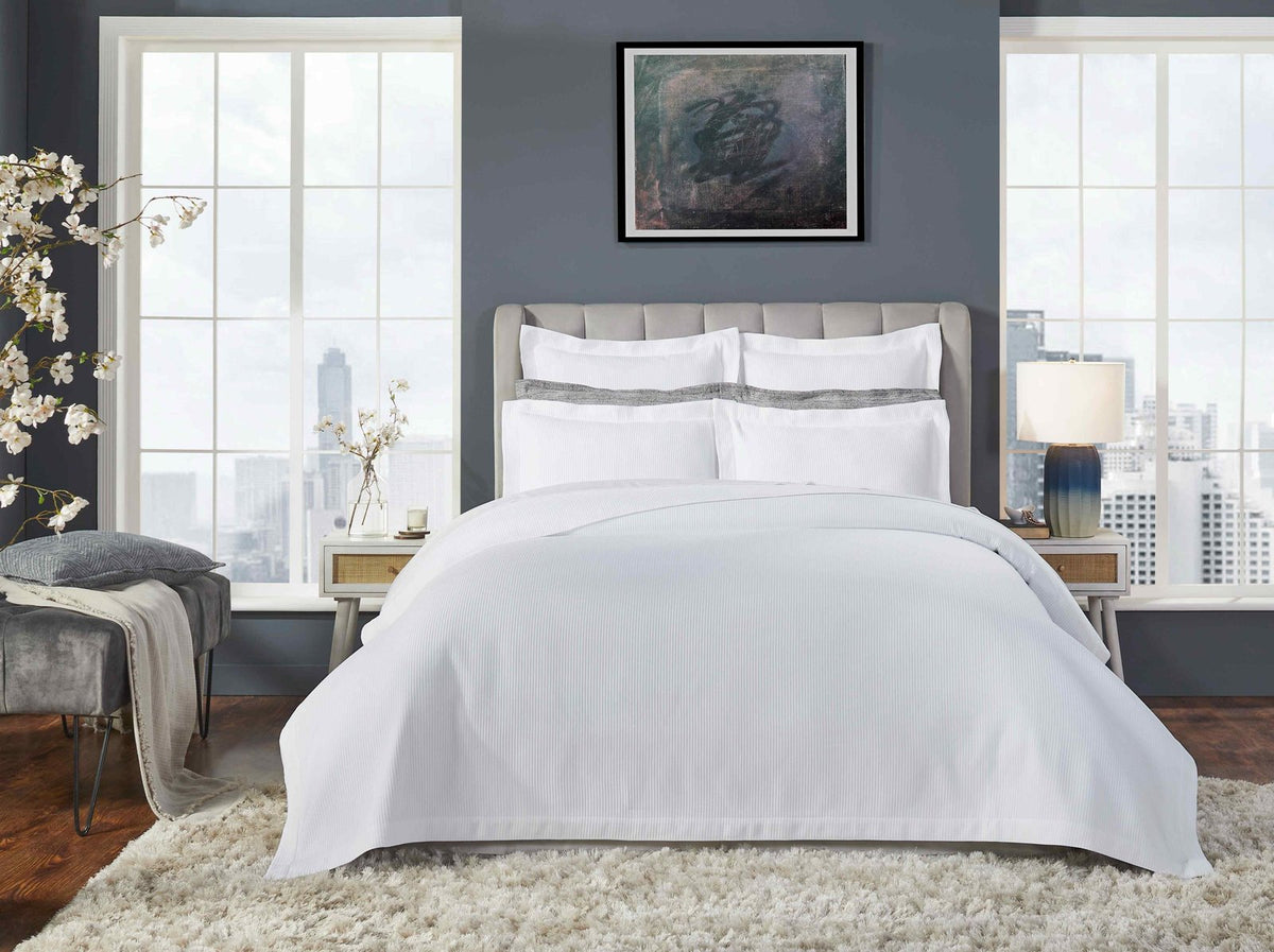 CL-191-X_1|Elegant white ribbed sateen sheet set and duvet cover, beautifully styled in a modern bedroom with cityscape views.