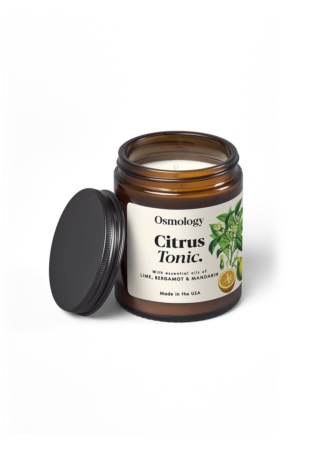 Osmology Citrus Tonic jar candle with open lid, on orange-cream background