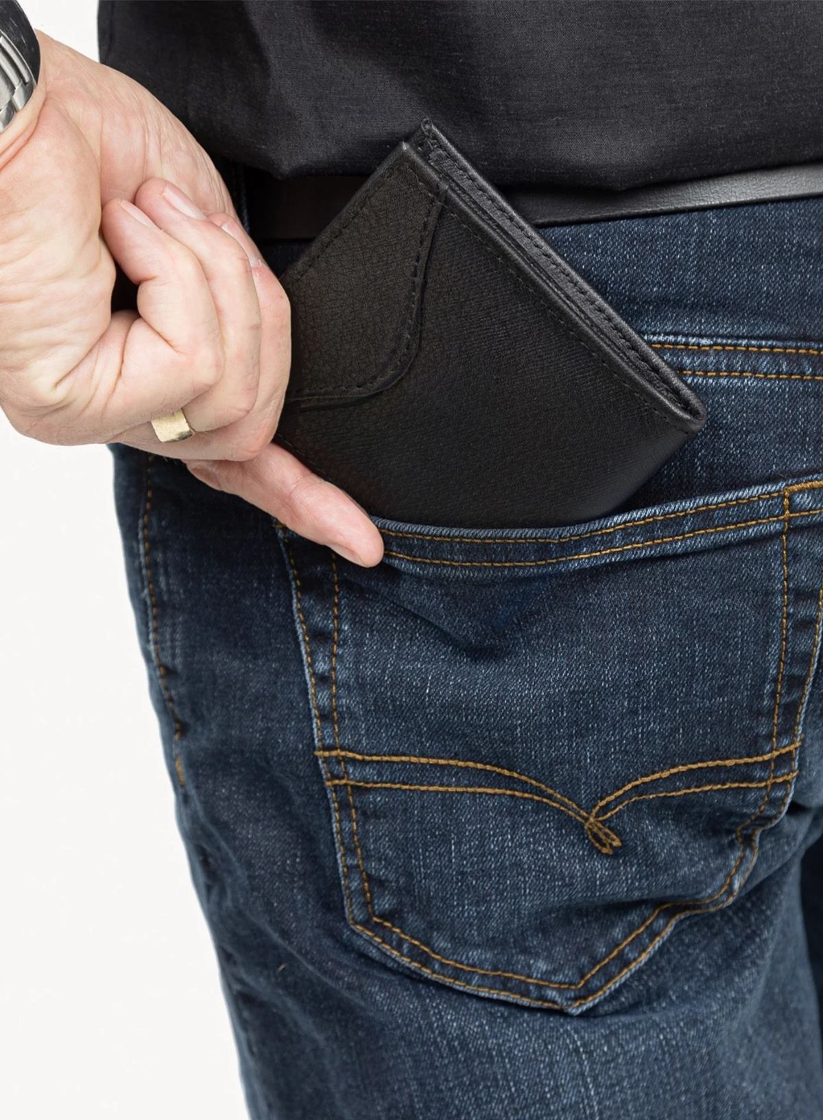 the shotgun wallet accessory for him in black detailed exterior model placing in pocket.