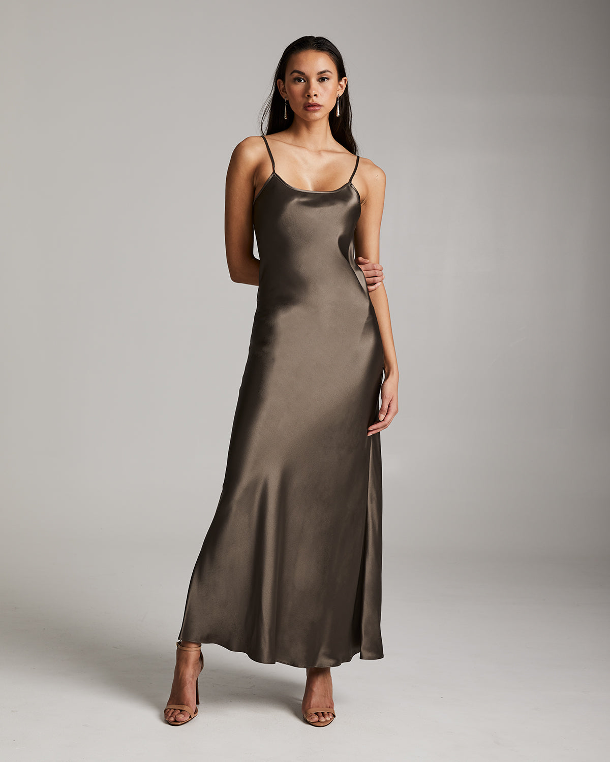 Model wearing a sage Liquid Silk Slipdress with spaghetti straps