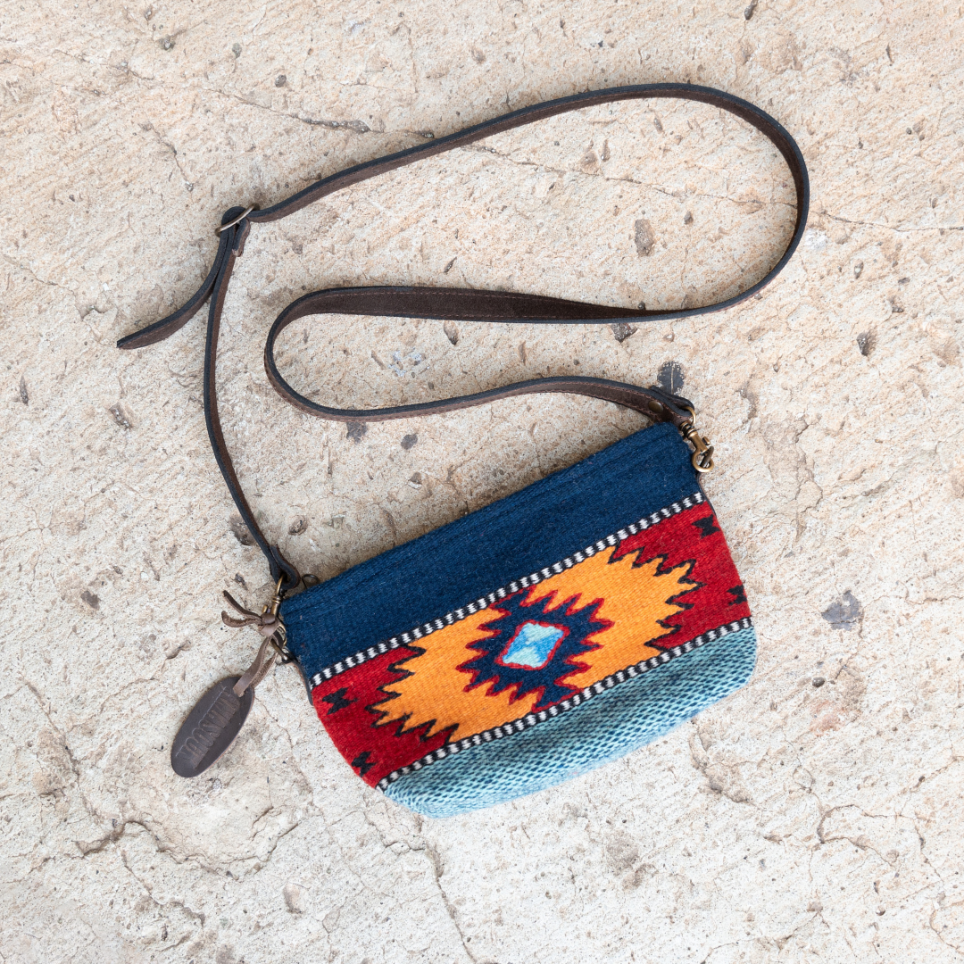 Handwoven convertible clutch with Zapotec pattern in bold colors; can be used as a pouch, wristlet, or crossbody with included leather straps and internal pocket.