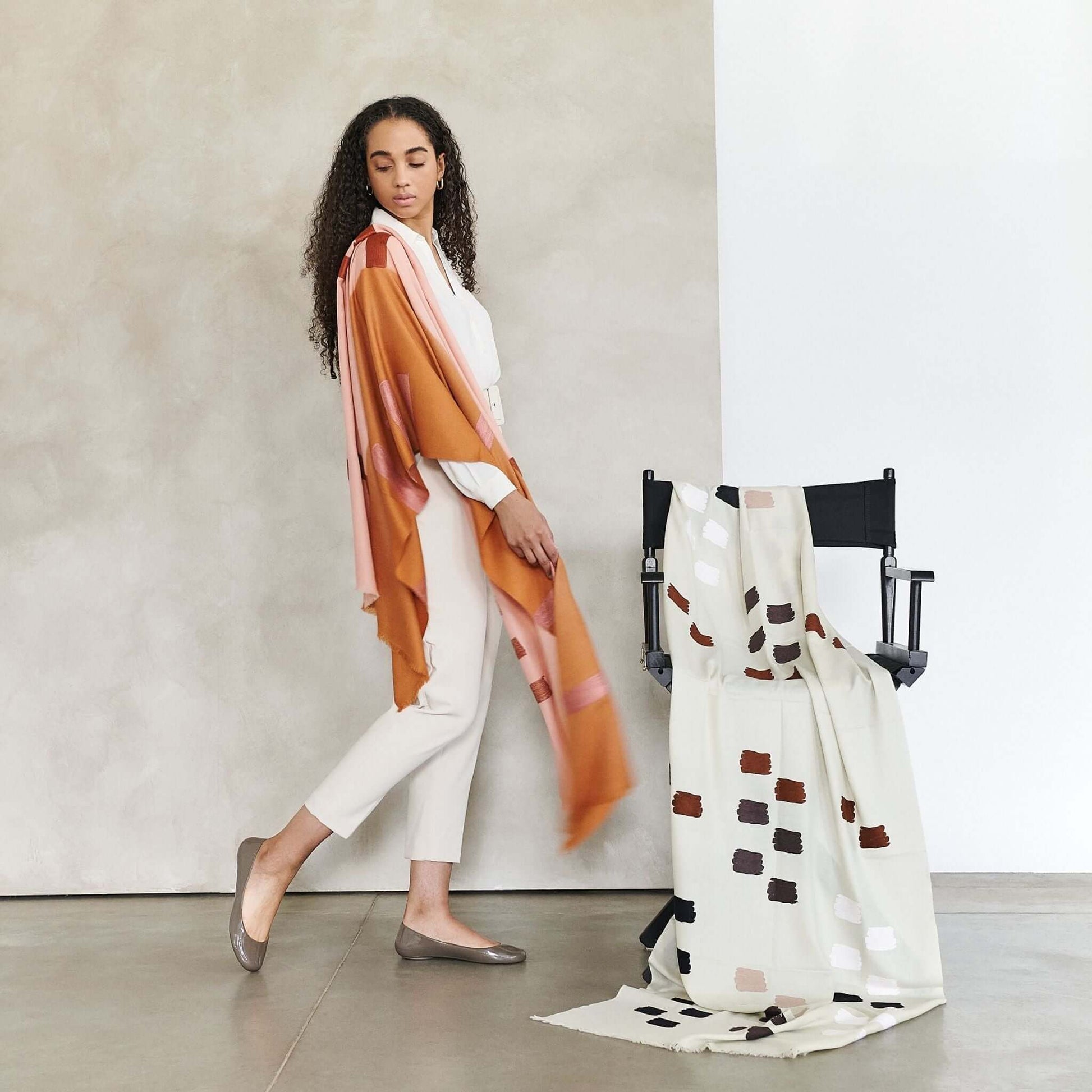 Canyon Hand Embroidered Hand Woven Merino Silk Soft Scarf draped elegantly on a model and chair in a chic setting.