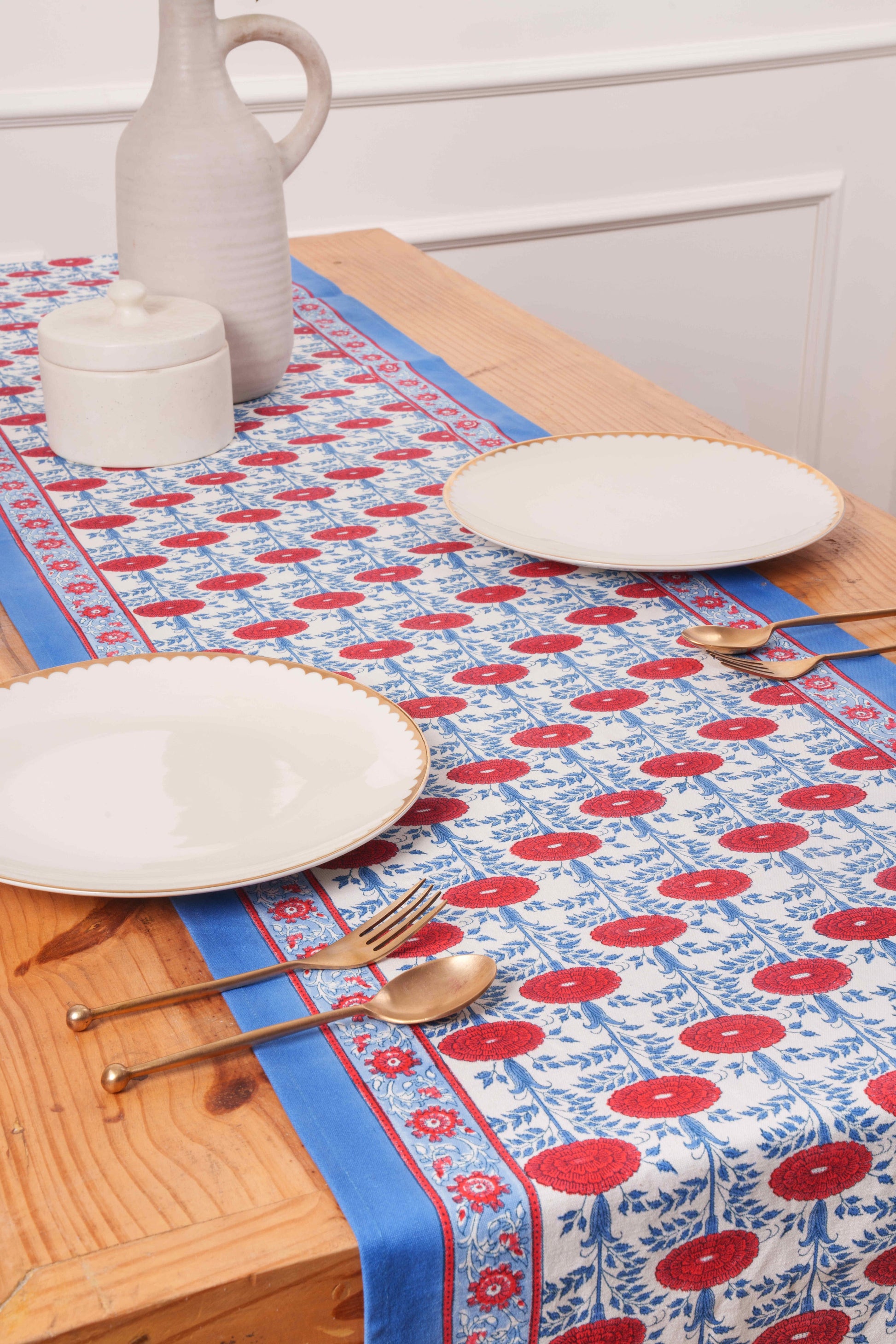 Inner Child Araminta Blockprint tablerunner with blue/red floral design, wooden table with plates and utensils