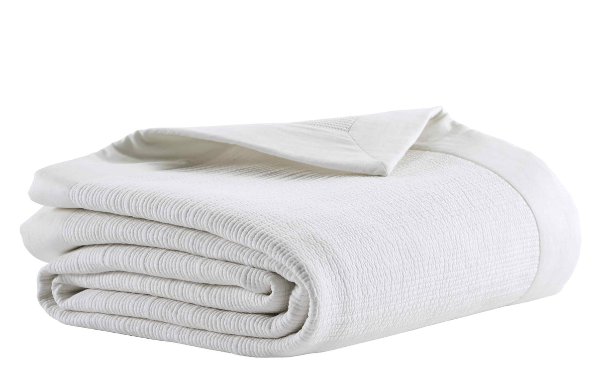 CL-168-7092_4|Folded white textured cotton blend coverlet, perfect for a cozy and elegant bedroom. High-quality bedding.