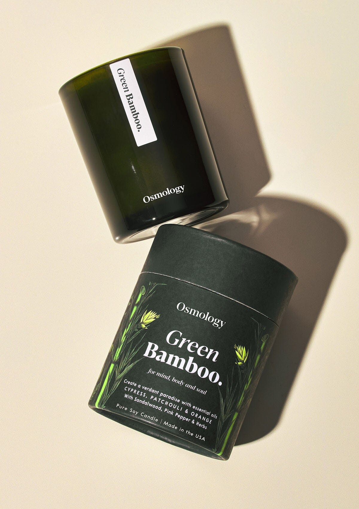 Osmology Green Bamboo candle with product packaging on white background 