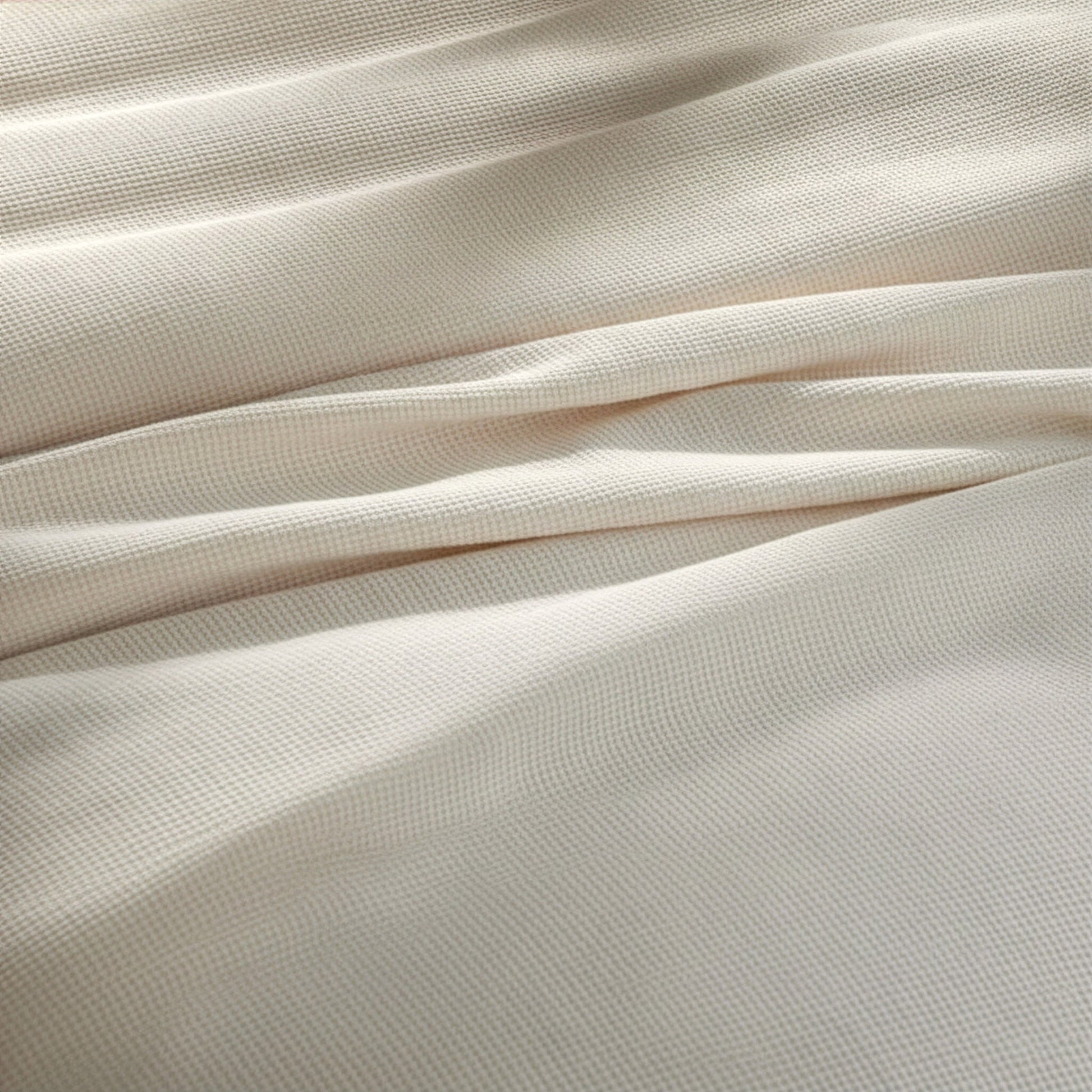 BL-860-9496_5|Detailed close-up of a soft light beige waffle weave blanket fabric, highlighting the texture and quality material.