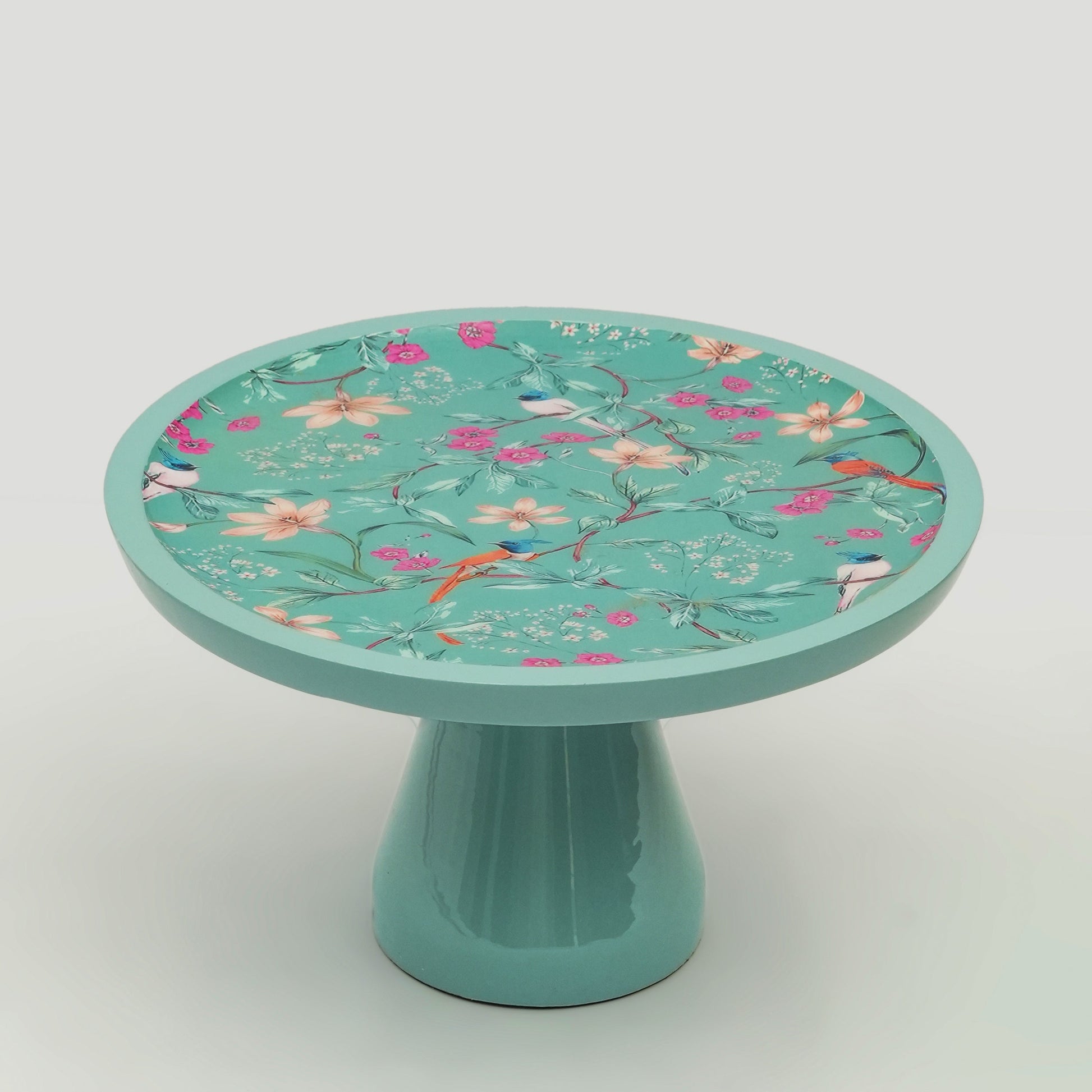 A slice of cake being lifted from the Aqua Flora decorative pedestal stand.