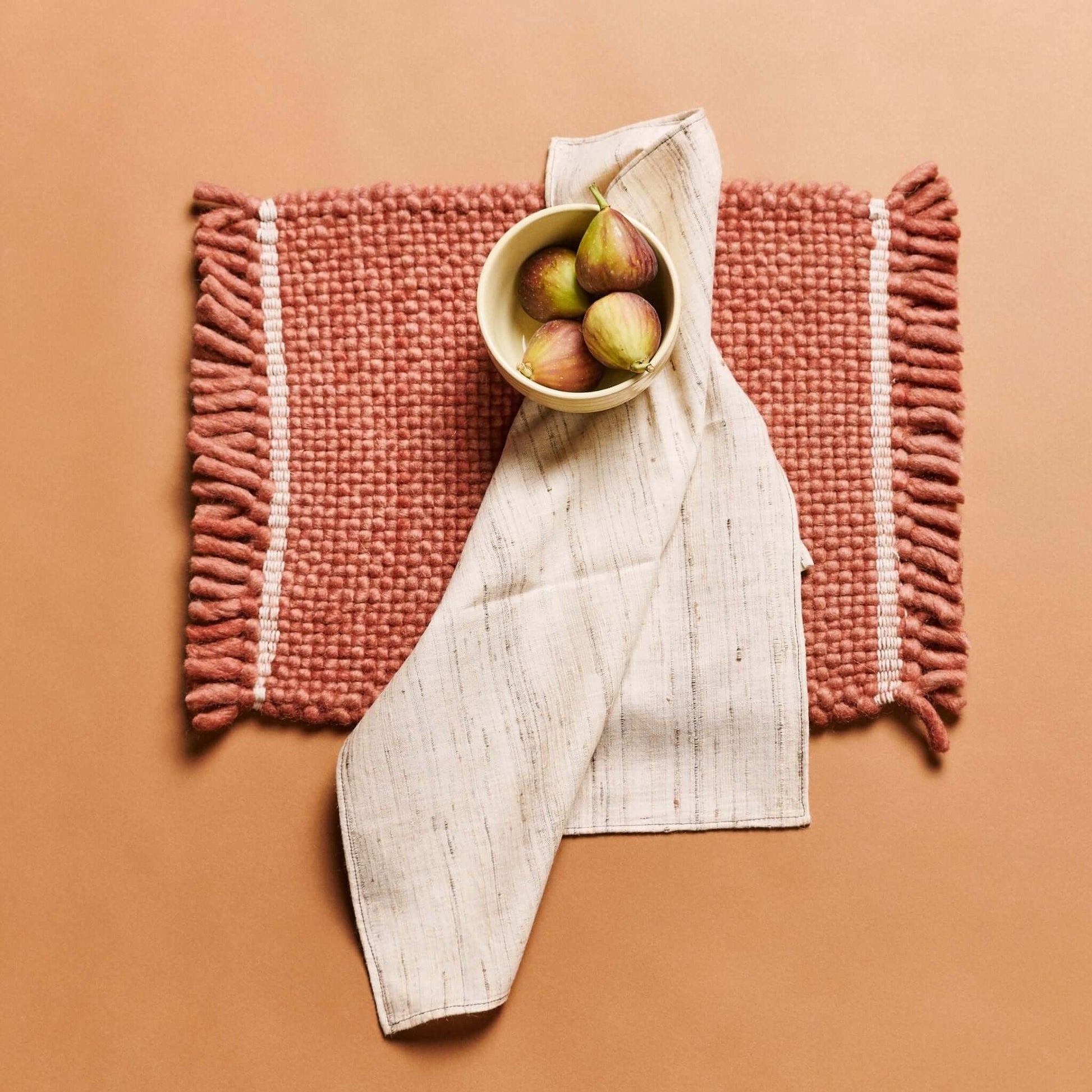 Kora Off White Peace Silk Handloom Napkin set of 4 displayed on a table with a bowl of figs.