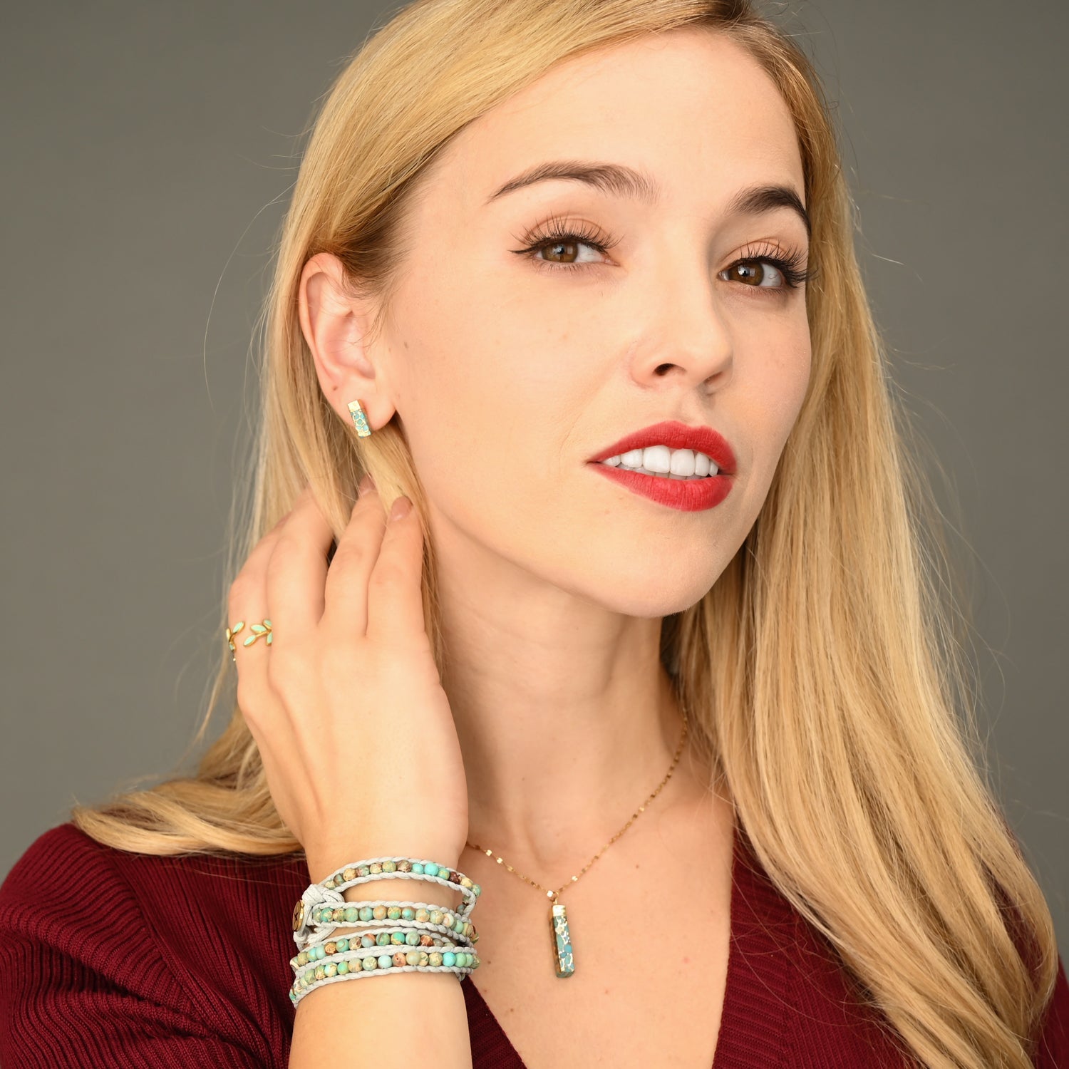 A woman wearing fashion jewelry, gold shade and turquoise studs, unique xmas gifts, jewelry business, gift set deals